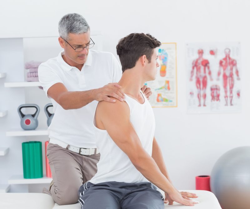 Chiropractor performing upper cervical spine adjustment to help relieve a patient’s neck pain, back pain, and vertigo in a clinical setting.
